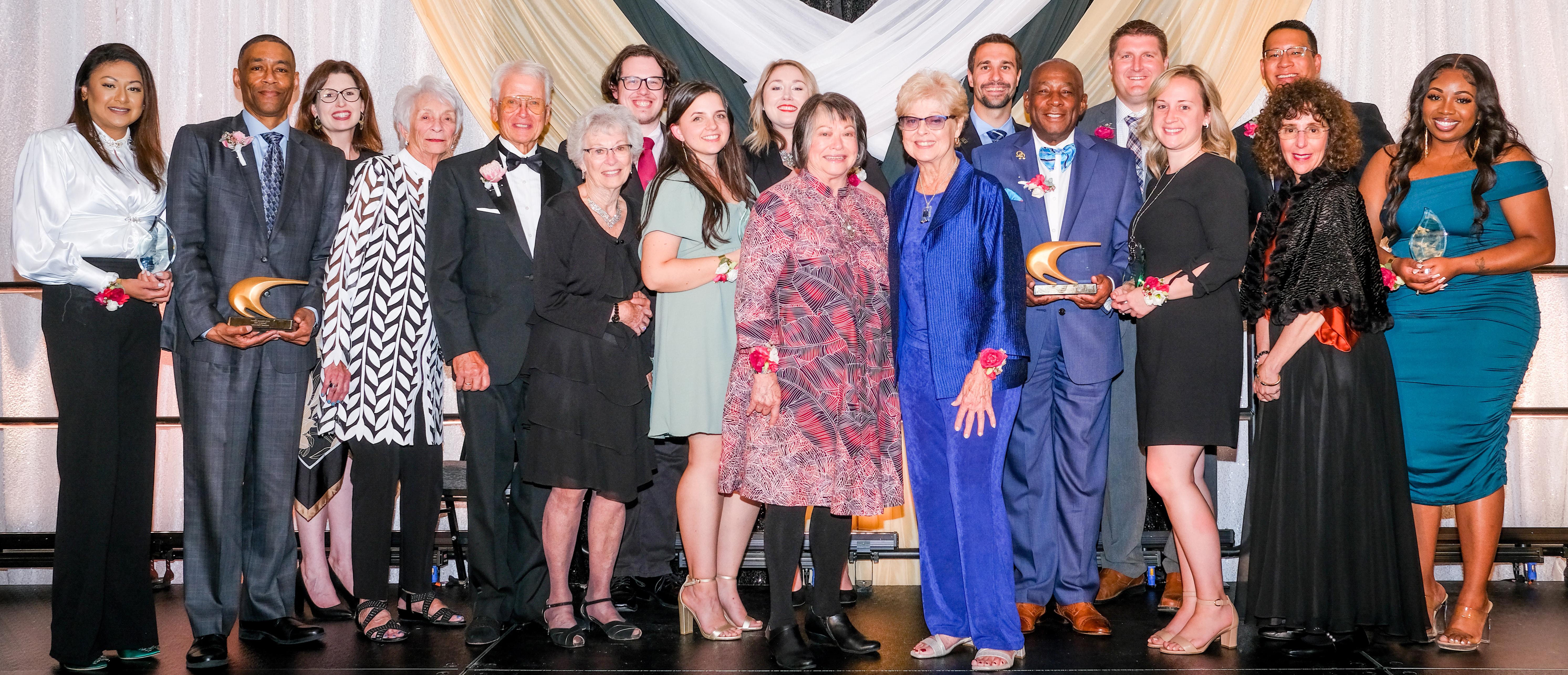 Image of Alumni holding their Night of Excellence Awards