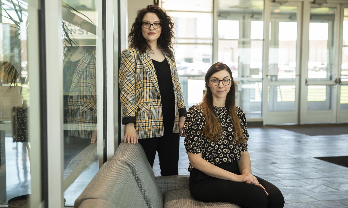 Photo of two female student smiling at the camera