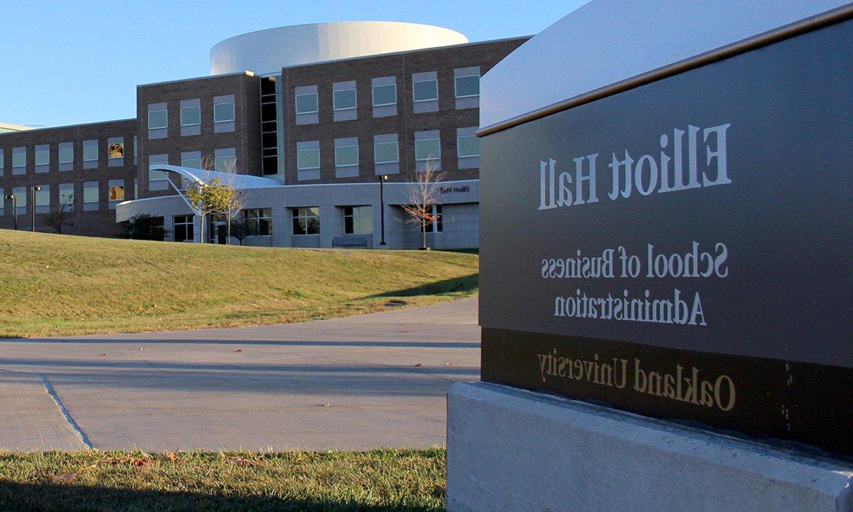 Exterior photo of building and sign. Sign reads Elliott Hall School of Business Administration. 