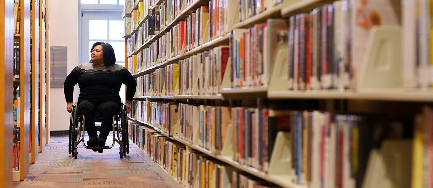 A wheelchair-abled woman in a library