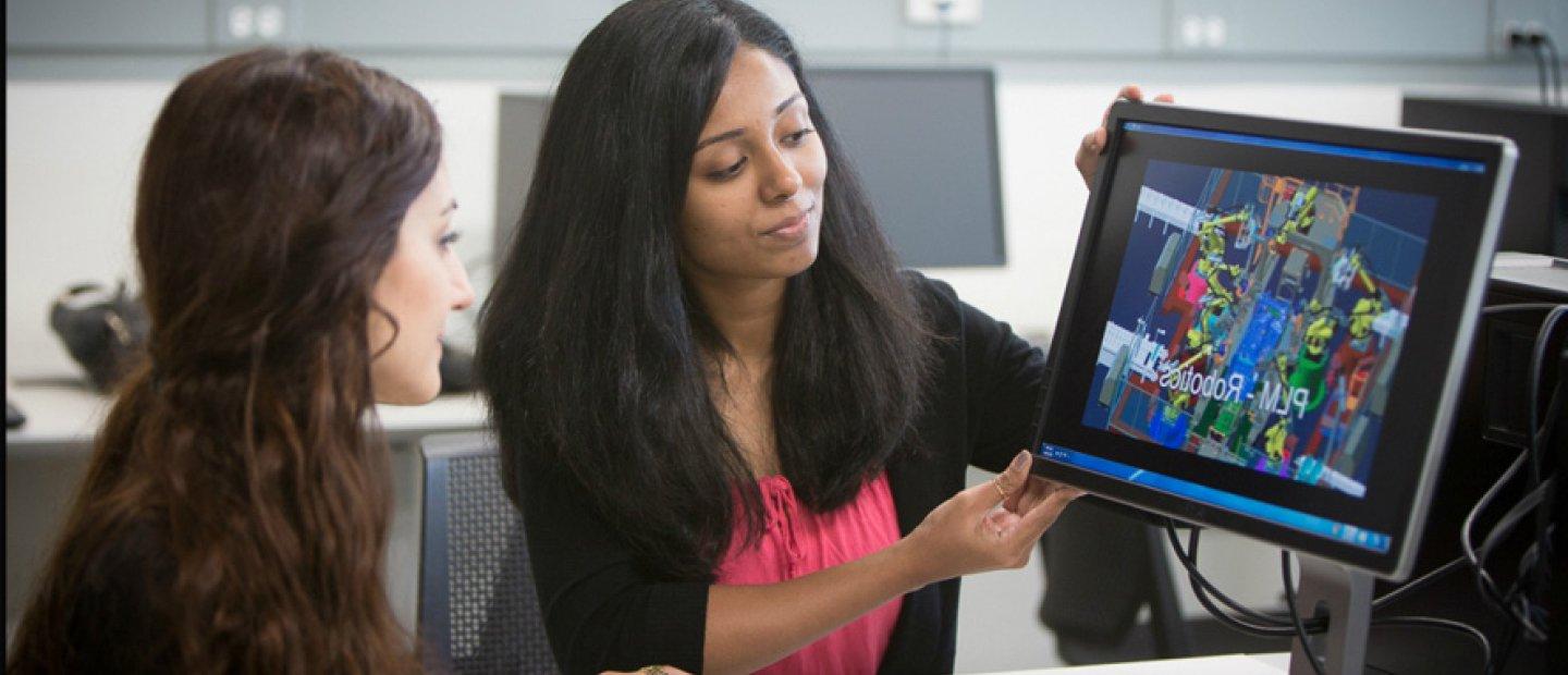 2 Female Students working on a touchscreen